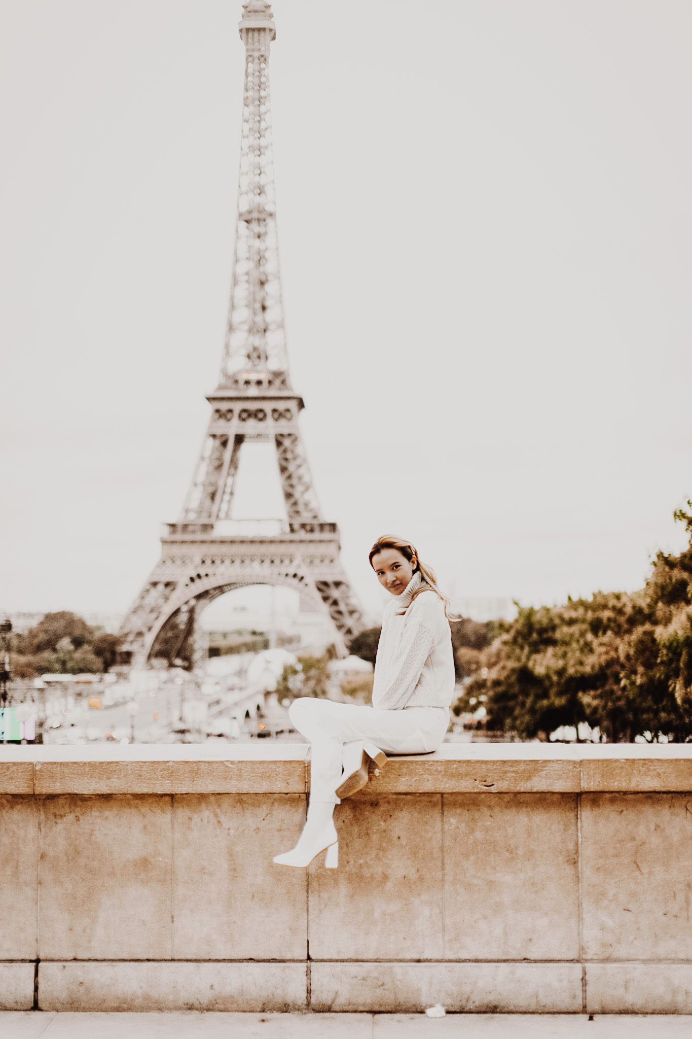 Matching white heeled boots in front of the Eiffel