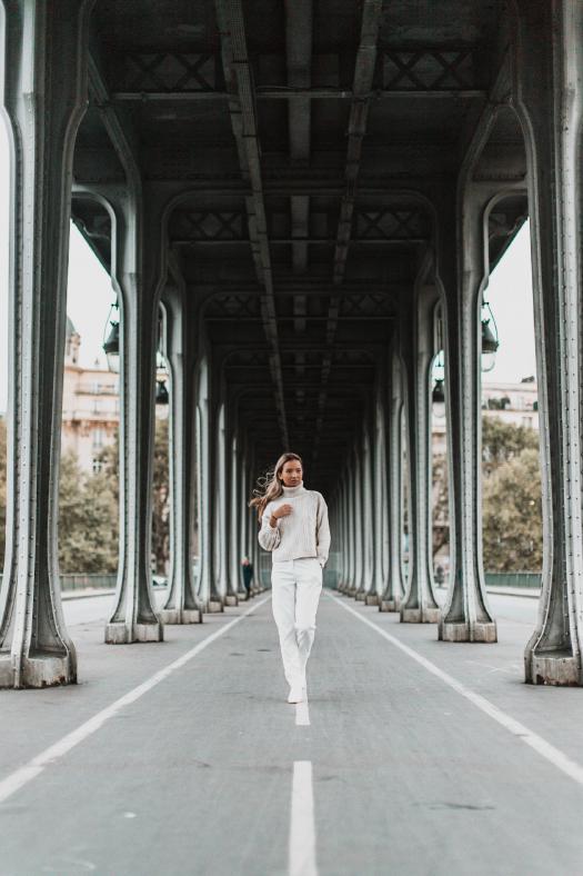 All white outfit under a bridge